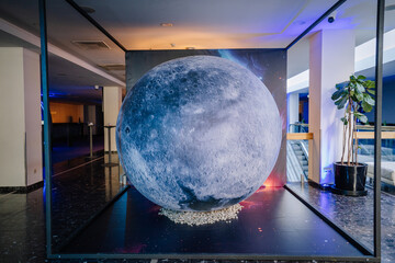 Moon-themed display at BALTA event foyer, featuring a realistic spherical model with galactic...