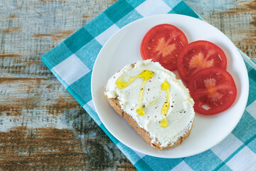 A simple, light, summer appetizer made of tomato bread and cheese