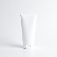 A sleek tube of white cream rests on a smooth grey background, showcasing its minimalist design and reflecting soft light, emphasizing its purity.