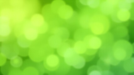 Obraz premium Abstract green bokeh background with blurred bright circles perfect for sp or summer designs and nature themes.