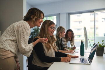 Group of young women collaborating in modern office workspace