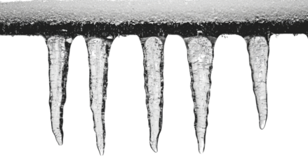 Png of Five long, sharp icicles hang from a snowy edge, reflecting light in a cold winter's atmosphere.