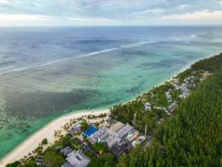 Aerial shot of beachfront resort and coral reef in Le Morne, Mauritius during overcast skies