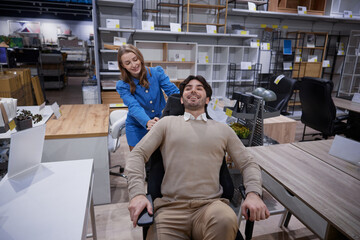 Two people relax in stylish office furniture showroom showcasing modern designs
