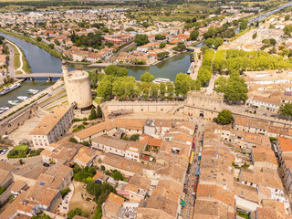 Aigues-Mortes, Camargue, France, medieval city with its surrounding walls, the Constance Tower, and typical southern french houses, canals for boats