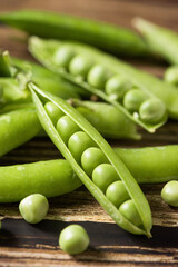 fresh green peas on wooden table.