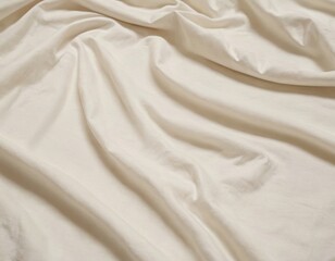 Fototapeta premium Soft beige fabric draped elegantly, creating gentle folds and textures.