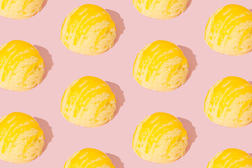 Yellow banana ice cream pattern on pastel pink background. Summer food concept. Minimal isometric layout. Ice cream scoop aesthetic background idea.