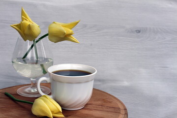 A cup of coffee will lift your spirits in a free moment, and tulips will make you smile