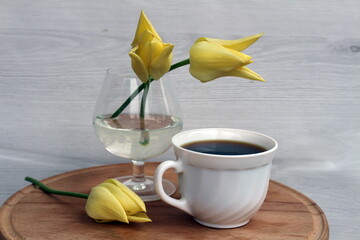 A cup of coffee will lift your spirits in a free moment, and tulips will make you smile