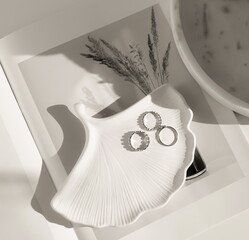 White podium leaf for jewerly and rings on white soft shadow background monochrome black and white. Copy space. Abstract minimal showcase, display. Top view, Flat lay.