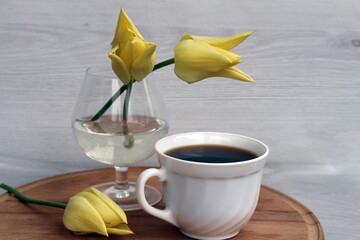 A cup of coffee will lift your spirits in a free moment, and tulips will make you smile