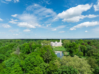 Palace in Dobra in spring. Aerial drone view of Palace and Park Complex in Dobra, a neoGothic palace surrounded by a park located in the Opole Voivodeship, Krapkowice district in village of Dobra.
