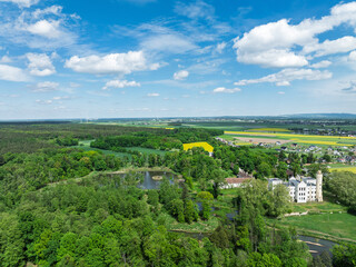 Palace in Dobra in spring. Aerial drone view of Palace and Park Complex in Dobra, a neoGothic...