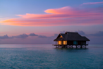 bungalow on the sea during sunset