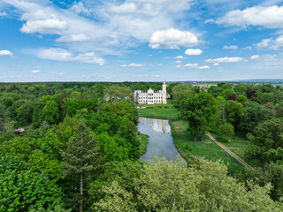 Palace in Dobra in spring. Aerial drone view of Palace and Park Complex in Dobra, a neoGothic...