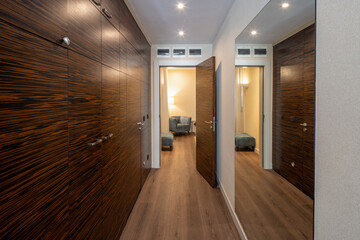 Interior of a long hotel corridor, doorway