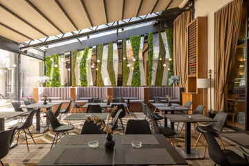 Trendy modern dining space with inviting atmosphere and soft seating and wall decoration