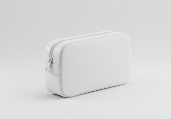 A minimalist white cosmetic bag with zipper closure sits on a white surface in a studio setting