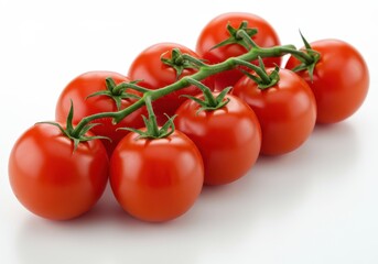 Vine of fresh, ripe red tomatoes with green stems arranged on a white surface in a studio setting