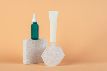 Cosmetic product in tube, bottle, lotion or serum with stylish props on cream background. 