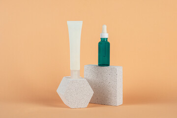 Plastic white tube for cream or lotion. Skin care or sunscreen cosmetic with stylish props on cream background.
