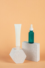Plastic white tube for cream or lotion. Skin care or sunscreen cosmetic with stylish props on cream background.