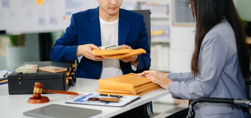 Lawyer refusing bribe money in the envelop from business man at the lawyer office.