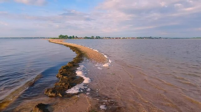 Wonderful summer seascape of Baltic sea with the end of the sandbar. Amazing endless clouds  in colorful sky. Nuicer morning scene of Rewa public beach, Poland. 4K video (Ultra High Definition).
