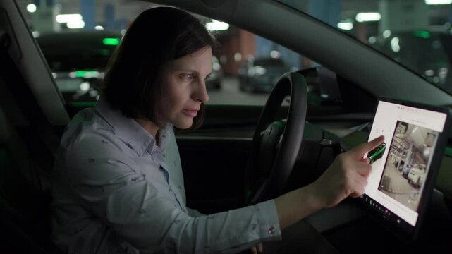 Woman Checking Car Camera on Touchscreen While Parked