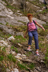 Woman descending rocky mountain path