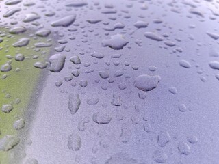 Water Droplets Gathering on a Gray Surface After Rain