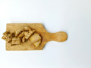 Preparing Fresh Ginger Root on Wooden Cutting Board
