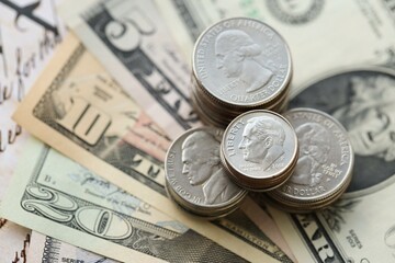 American US dollars money bills with coins and constitution close up on american flag