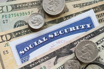 American US dollars money bills, social security number card and on American flag