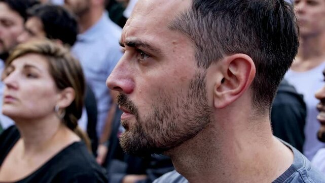 Diverse crowd focused on event with intense anticipation and emotion