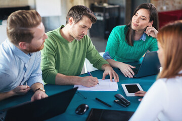 Young software developers in coworking open space
