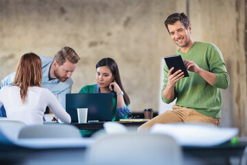 Young software developers at work using technology