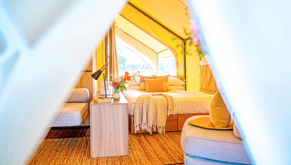  Bright & Cozy Glamping Tent Interior: Stylish Bed with Warm Decor & Natural Light. Luxury Camping & Relaxing Outdoor Lifestyle Getaway