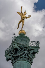 Fototapeta premium Paris, France - 05 03 2025: Place de la Bastille. Detail View of the genius of Liberty golden statue on July column.
