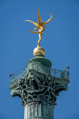 Paris, France - 05 03 2025: Place de la Bastille. Detail View of the genius of Liberty golden statue on July column.