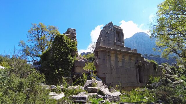 4K Ancient Roman bath ruins in Termessos, an abandoned Pisidian city hidden in the Taurus Mountains (Gulluk Mountain) near Antalya, Turkey. Overgrown ruins surrounded by greenery and mountain