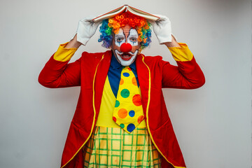 Clown covering head with a book