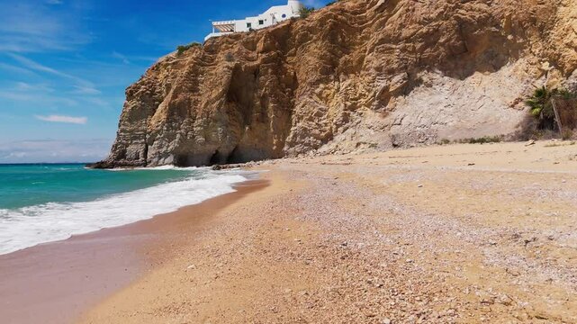 Backtracking drone view revealing scenic beach nestled in rocky Mediterranean cove