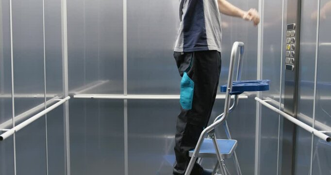 Elevator technician fixing the elevator