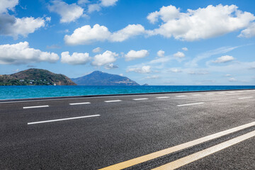 Empty asphalt road and blue sea with mountain natural landscape under blue sky