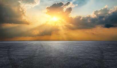 Empty asphalt road and tire track with beautiful sky clouds at sunset