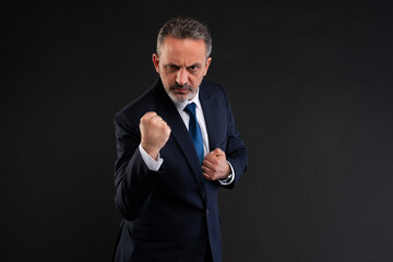 Determined businessman making a fist in defiance.