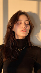 Fototapeta premium Young woman with eyes closed in warm light