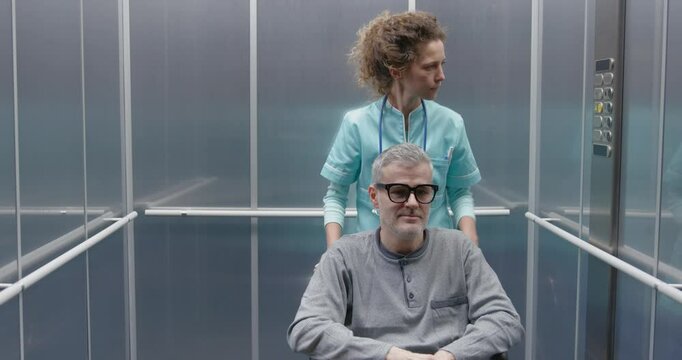 Patient in wheelchair and doctor in the hospital elevator